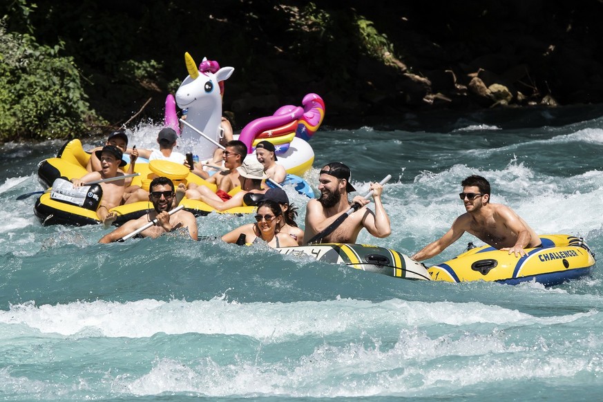 People enjoy the sun on the Aare River, at Uttigen, between Thun and Bern, Switzerland, during the sunny and warm weather, Sunday, June 30, 2019. The forecast predicts hot weather in Switzerland with  ...