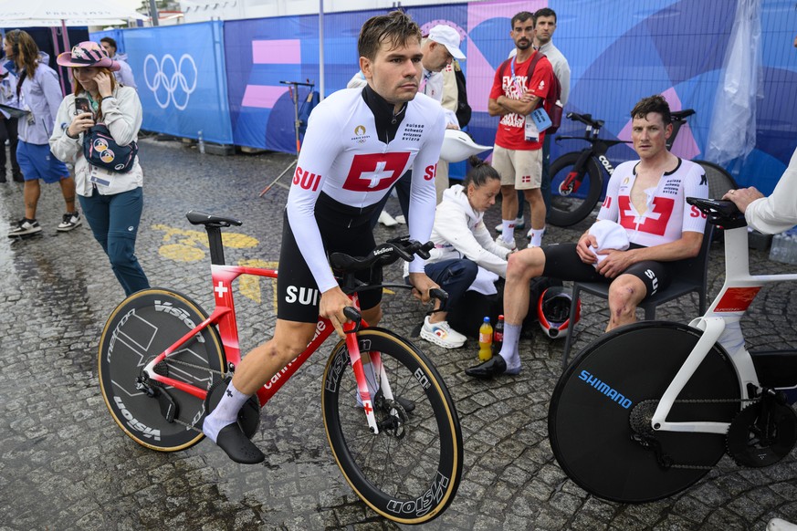 Stefan Kueng, right, of Switzerland Stefan Bissegger, left, of Switzerland react after crossing the finish line during the men's cycling individual time trial at the 2024 Paris Summer Olympics in ...