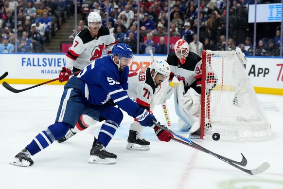 Toronto Maple Leafs centre Nicolas Roy (55) and New Jersey Devils defenceman Jonas Siegenthaler (71) vie for control of the puck during second period NHL hockey action in Toronto, Tuesday, Oct. 21, 20 ...