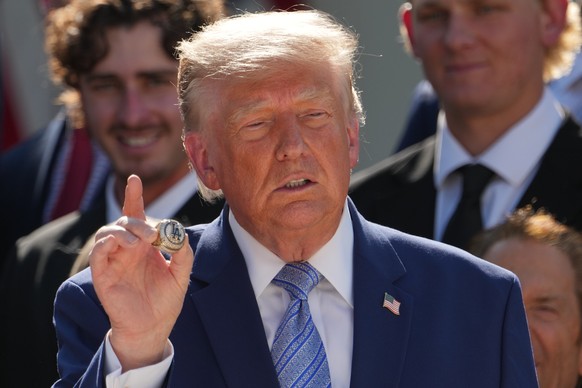 President Donald Trump holds a championship ring during an event to honor the 2025 World Series champions Los Angeles Dodgers in the Rose Garden of the White House, Thursday, July 23, 2026, in Washing ...