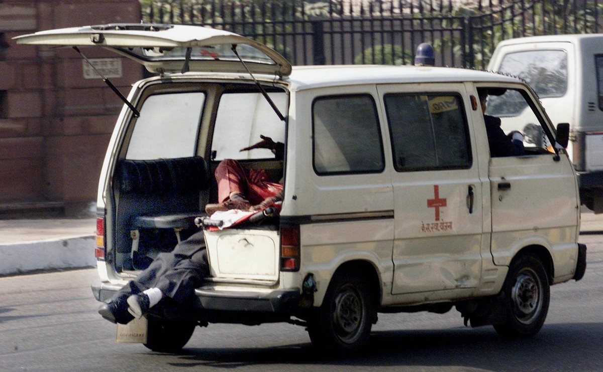 An ambulance rushes to a nearby hospital carrying the injured of the Parliament house shooting spree in New Delhi, India, Thursday Dec. 13, 2001. Gunfire and an explosion erupted India�s Parliament ho ...