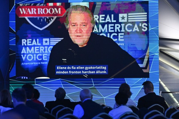 epa10610967 Steve Bannon, former chief strategist in the administration of US former President Donald Trump, appears on the screen as he delivers his video message during the second day session of the ...