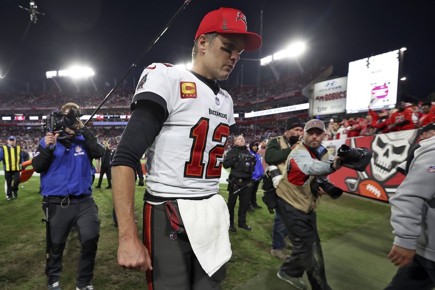 Tampa Bay Buccaneers quarterback Tom Brady (12) reacts as he leaves the field after the team lost to the Los Angeles Rams during an NFL divisional round playoff football game Sunday, Jan. 23, 2022, in ...