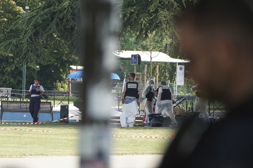 Police officers work at the scene after a knife attack Thursday, June 8, 2023 in Annecy, French Alps. A man with a knife stabbed several very young children, including at least one in a stroller, and ...