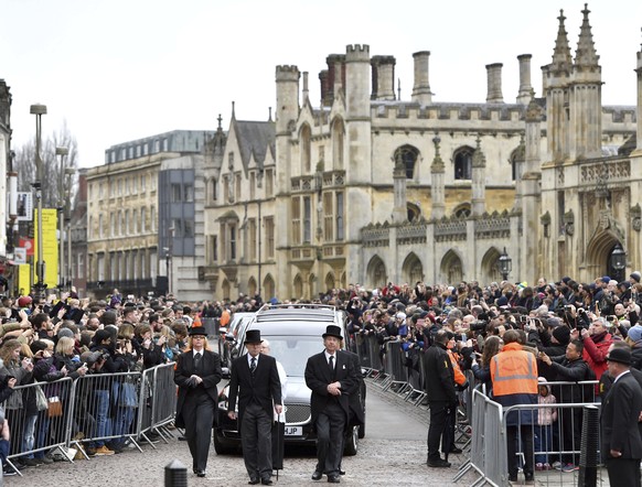 The hearse containing Professor Stephen Hawking arrives at University Church of St Mary the Great as mourners gather to pay their respects, in Cambridge, England, Saturday March 31, 2018. The renowned ...