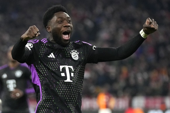 Bayern&#039;s Alphonso Davies celebrates after Harry Kane scored the opening goal with Thomas Mueller, right, and Konrad Laimer during the Champions League group A soccer match between Bayer Munich an ...