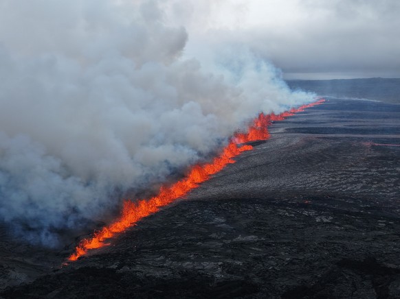 epa12241071 A handout photo made available by the Icelandic Civil Protection shows lava emerging following a volcano eruption near Grindavik, Reykjanes, Iceland, 16 July 2025. EPA/ICELANDIC CIVIL PROT ...