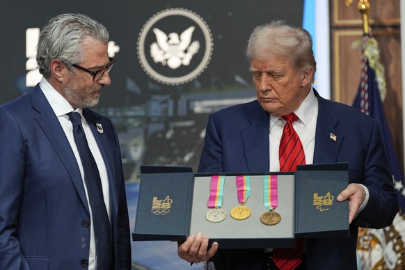 KEYPIX - President Donald Trump listens as Casey Wasserman, chairman of LA28, presents him a full set of medals from the 1984 Olympics in Los Angeles, during an event regarding the 2028 Los Angeles Ol ...