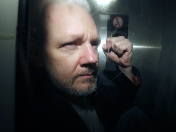 FILE - WikiLeaks founder Julian Assange being taken from court, where he appeared on charges of jumping British bail seven years ago, in London, Wednesday May 1, 2019. Britain&#039;s High Court is set ...