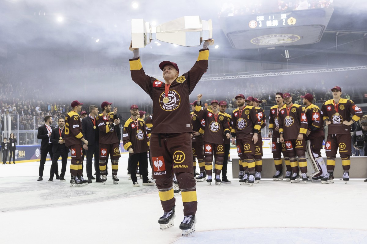 Geneve-Servette's forward Sakari Manninen lifts the trophy after winning at the Champions Hockey League Final game between Switzerland's Geneve-Servette HC and Sweden's Skelleftea AIK,  ...