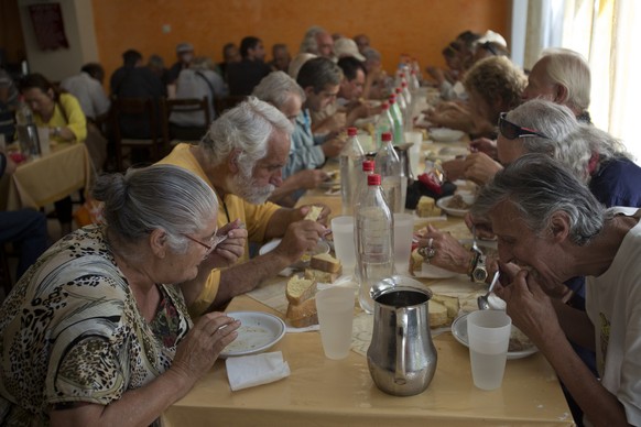 Needy people eat at the Church-run Galini charity&#039;s soup kitchen in central Athens on Monday, July 6, 2015. GreeceÂs finance minister has resigned following SundayÂs referendum in which the maj ...