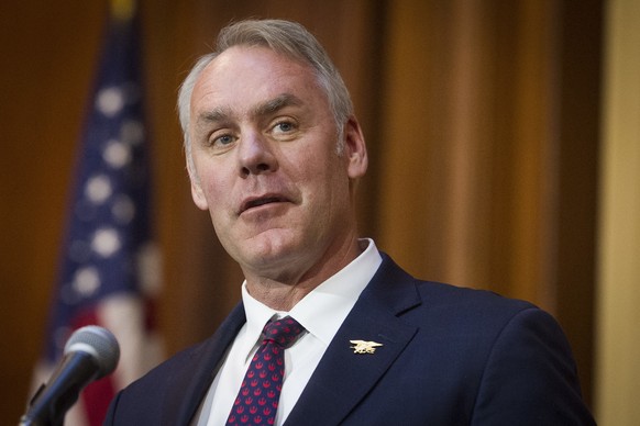 FILE - In this Dec. 11, 2018 file photo, Secretary of the Interior Ryan Zinke speaks after an order withdrawing federal protections for countless waterways and wetland was signed, at EPA headquarters  ...