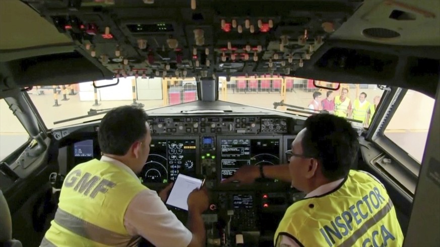 In this image from video taken on Tuesday, March 12, 2019, officials make inspection inside the cockpit of a Boeing 737 Max 8 aircraft is in hangar at Garuda Maintenance Facility at Soekarno Hatta air ...