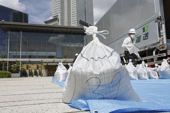 A bag of soil, slightly radioactive but decontaminated one from Fukushima, is delivered to the Japanese prime minister&#039;s office to be reused in the garden, in Tokyo, Japan, Saturday, July 19, 202 ...