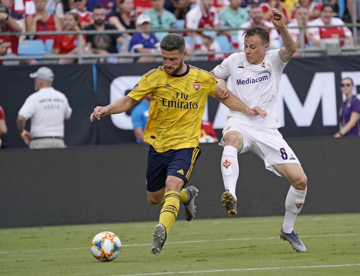 Fiorentina's Szymon Zurkovski, right, battles Arsenal's Shkodran Mustafi, left, for the ball during the second half of an International Champions Cup soccer match in Charlotte, N.C., Saturda ...