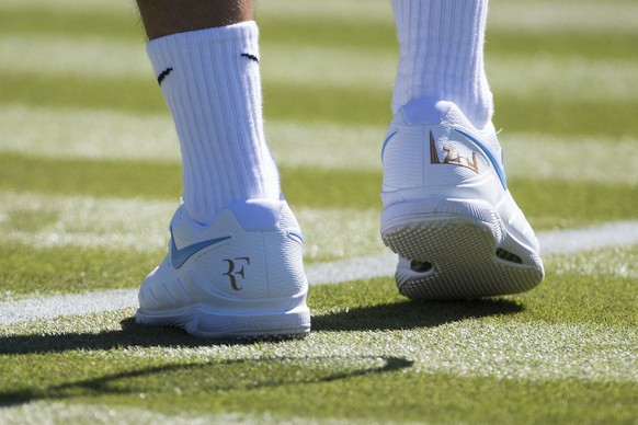 Roger Federer of Switzerland wears Nike shoes with his logo during a training session at the All England Lawn Tennis Championships in Wimbledon, London, Wednesday, June 27, 2018. The Wimbledon Tennis  ...