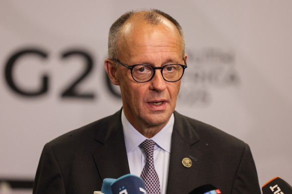 epa12542163 German Chancellor Friedrich Merz address the media at the Nasrec Expo Centre during the Group of Twenty (G20) Leaders&#039; Summit in Johannesburg, South Africa, 22 November 2025. World le ...