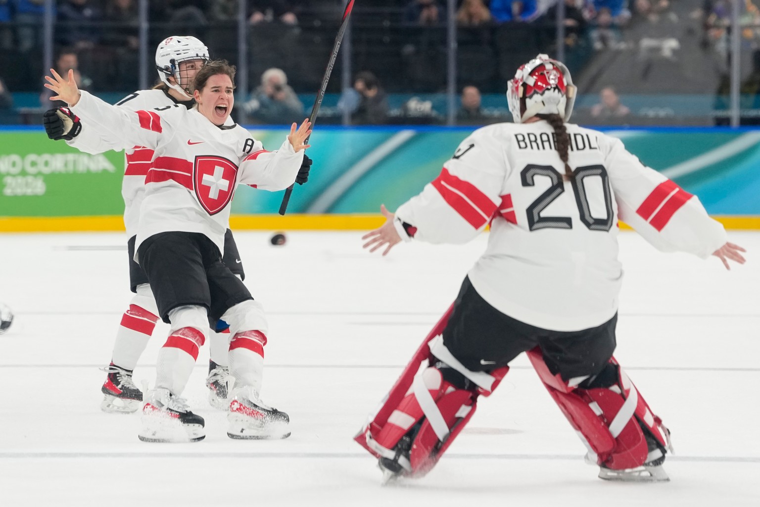 Switzerland's Alina Muller (25) celebrates with Switzerland's Andrea Braendli (20) after a women's ice hockey bronze medal game between Switzerland and Sweden at the 2026 Winter Olympic ...