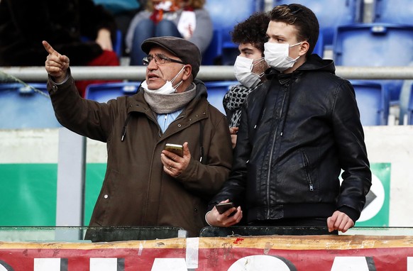 epa08241667 Roma supporters wear protective face masks due to the Coronavirus COVID-19 epidemic prior to the Italian Serie A soccer match between AS Roma and US Lecce at the Olimpico stadium in Rome,  ...