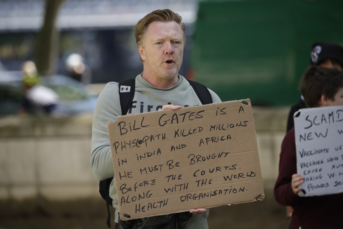 A man holds up an anti Bill Gates placard at a coronavirus anti-lockdown, anti-vaccine, anti-5G and pro-freedom protest near Scotland Yard, the headquarters of London's Metropolitan Police Servic ...