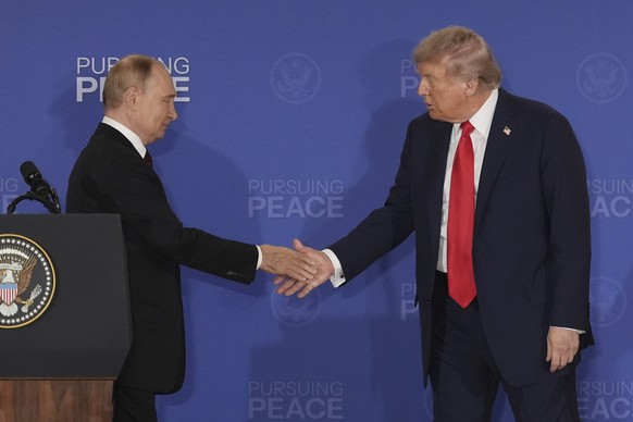 FILE - President Donald Trump, right, shakes the hand of Russia&#039;s President Vladimir Putin during a joint press conference at Joint Base Elmendorf-Richardson, Alaska, Aug. 15, 2025. (AP Photo/Jae ...