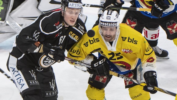 From left, LuganoÄôs player Ryno Johan and Bern's player Andrew Ebbet, during the preliminary round game of National League A (NLA) Swiss Championship 2019/20 between HC Lugano and SC Bern at the ice ...
