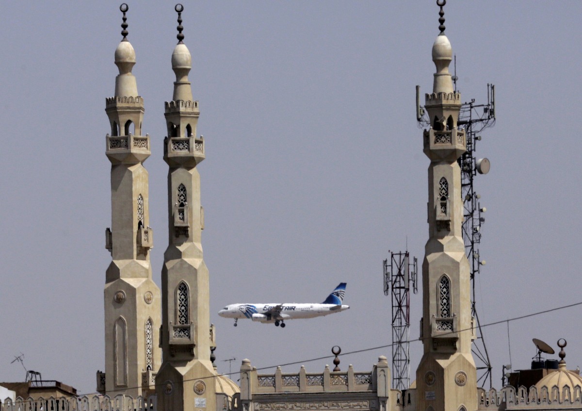 FILE - In this May 21, 2016, file photo, an EgyptAir plane flies past minarets of a mosque as it approaches Cairo International Airport, in Cairo, Egypt. A new U.S. security measure targeting flights  ...