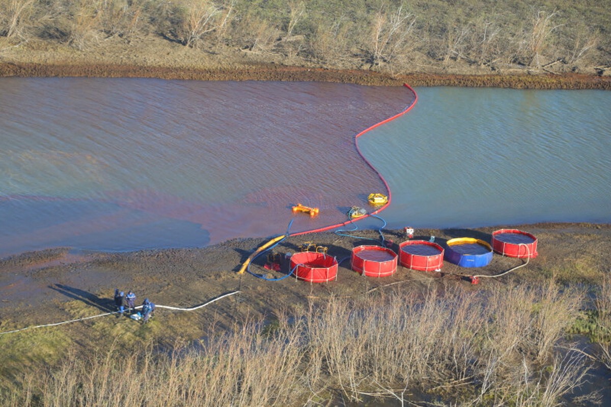 epa08474705 A handout picture made available by the press service of the Public Joint Stock Company 'Transneft' shows an aerial view of rescue works the site of oil products spill into the A ...