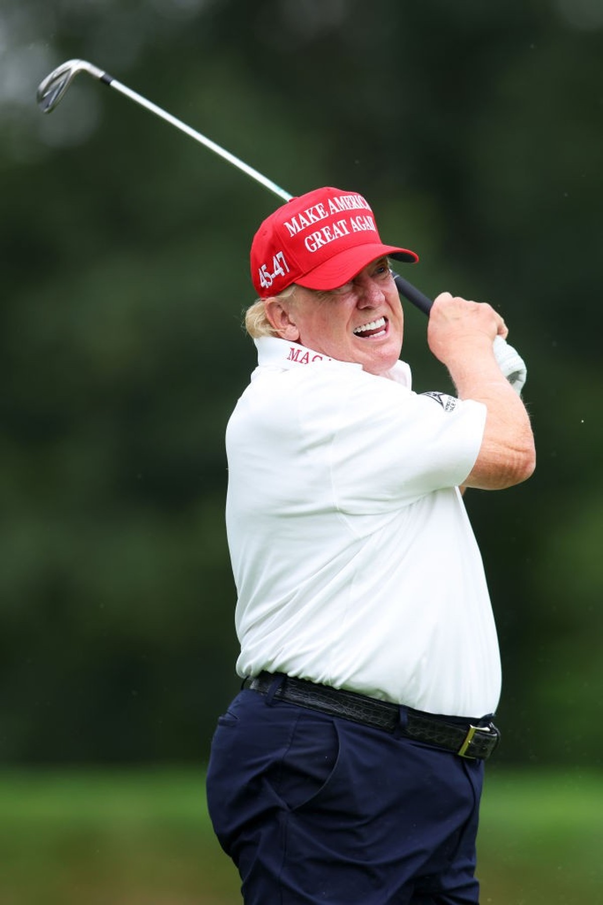 BEDMINSTER, NEW JERSEY - AUGUST 10: Former President Donald Trump follows his tee shot on the 3rd tee during the pro-am prior to the LIV Golf Invitational - Bedminster at Trump National Golf Club on A ...