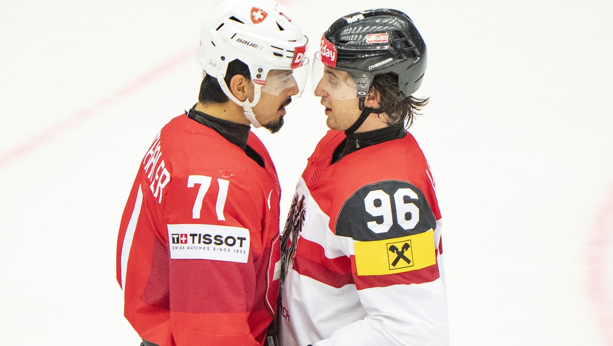 epa12126207 Jonas Siegenthaler, Switzerland, left in action with Marco Kasper, Austria, right during the quarter-final match between Switzerland and Austria at the IIHF Ice Hockey World Championships  ...