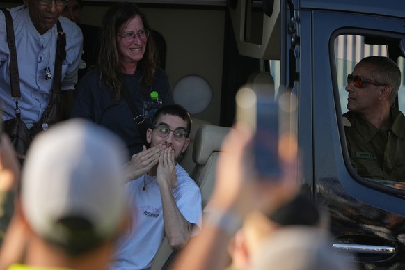 Freed Israeli hostage Evyatar David gestures from a van as he arrives at Beilinson hospital in Petah Tikva, Israel, after he was released from Hamas captivity in the Gaza Stripl, Monday, Oct. 13, 2025 ...