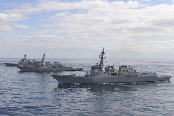 epa10483026 A handout photo made available by the South Korean Defense Ministry shows South Korean destroyer KDX-111 (front), US destroyer DDG-52, Barry (center) and Japanese destroyer DDG-177 JS (bac ...