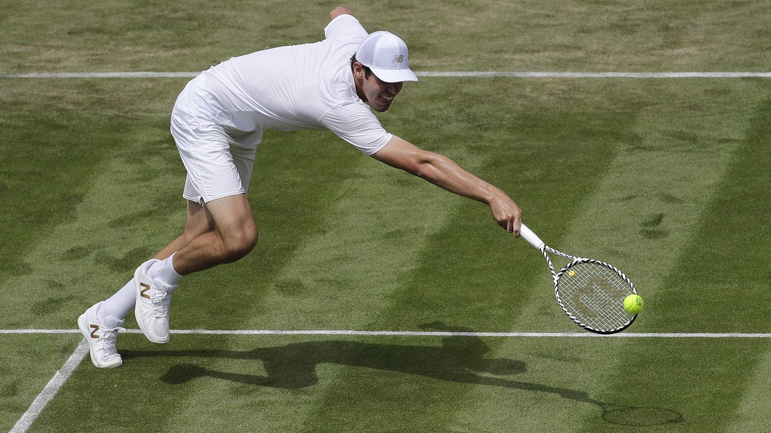 United States&#039;Reilly Opelka returns to Switzerland&#039;s Stan Wawrinka in a Men&#039;s singles match during day three of the Wimbledon Tennis Championships in London, Wednesday, July 3, 2019. (A ...