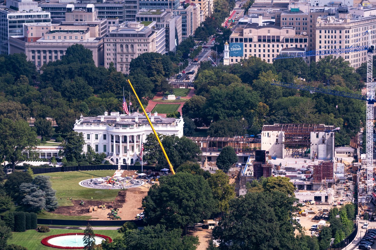 Construction continues on a helipad, left, on the South Lawn of the White House and and the new White House ballroom, right, as seen from the Washington Monument in Washington, Friday, Aug. 28, 2026.  ...