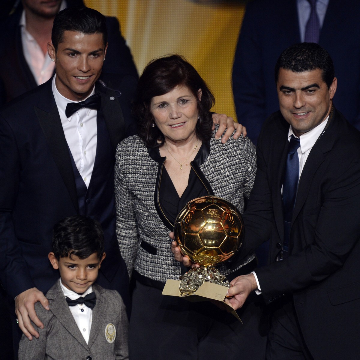 Cristiano Ronaldo, top left, of Portugal, his son Cristiano Jr., his mother Maria Dolores dos Santos Aveiro and his brother Hugo pose with the trophy after winning the FIFA Men's soccer player of ...