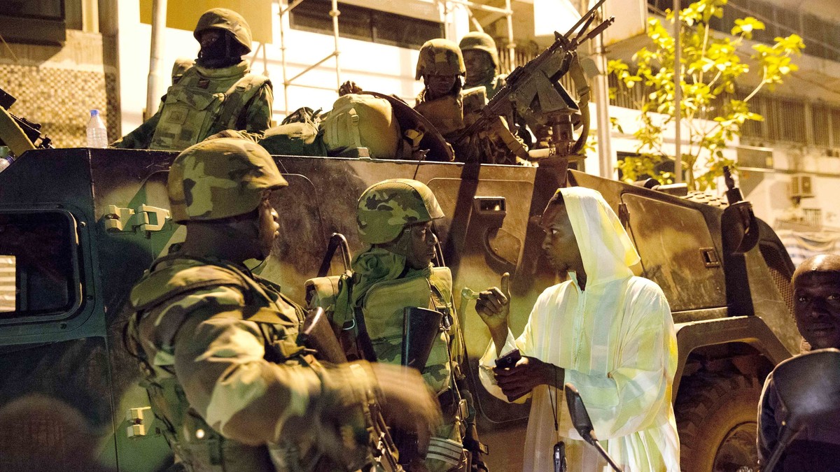 FILE - A man welcomes ECOWAS Senegalese troops as they take position near the state house in the Gambian capital Banjul Jan. 22, 2017. West Africa's regional bloc known as ECOWAS has threatened t ...