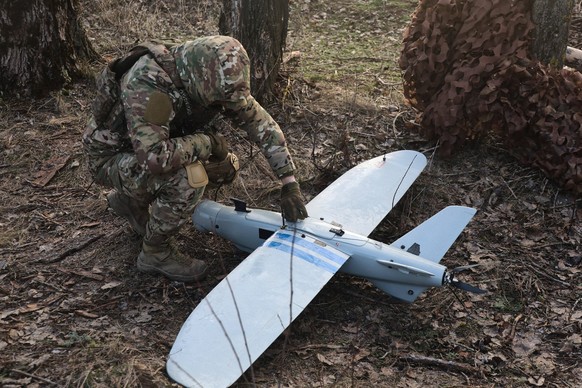 Leleka air reconnaissance drone crew of Ukraines 129th Brigade in Kharkiv direction A soldier from the 129th Heavy Mechanised Brigade squats by a Leleka air reconnaissance drone as a UAV crew performs ...