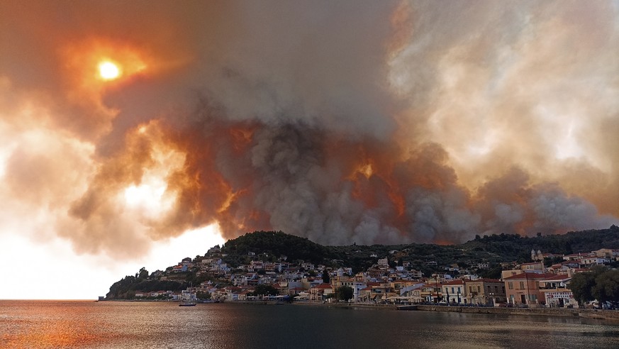 Flames burn on the mountain near Limni village on the island of Evia, about 160 kilometers (100 miles) north of Athens, Greece, Tuesday, Aug. 3, 2021. Greece Tuesday grappled with the worst heatwave i ...
