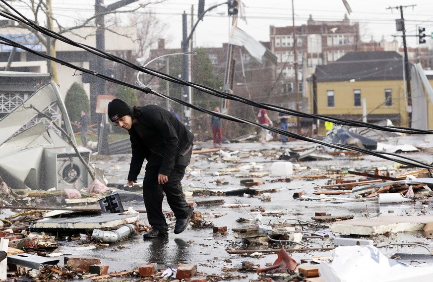 A man walks through storm debris following a deadly tornado Tuesday, March 3, 2020, in Nashville, Tenn. Tornadoes ripped across Tennessee early Tuesday, shredding buildings and killing multiple people ...