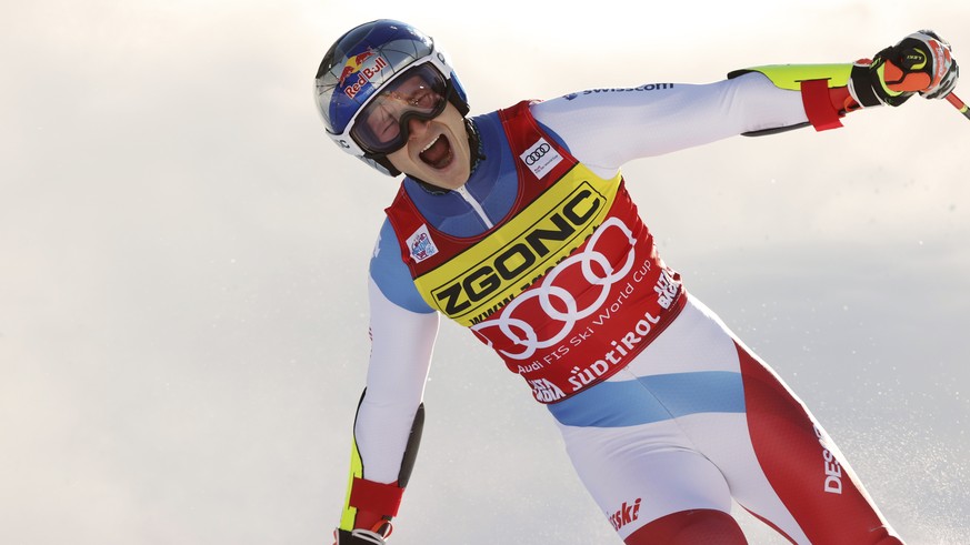 Switzerland&#039;s Marco Odermatt celebrates at finish area after winning an alpine ski, men&#039;s World Cup giant slalom race in Alta Badia, Italy, Monday, Dec. 20, 2021. (AP Photo/Alessandro Trovat ...