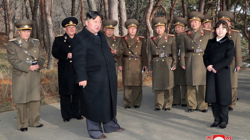 epa10512828 A photo released by the official North Korean Central News Agency (KCNA) shows Supreme Leader Kim Jong Un (3-L) and his daughter Kim Ju-ae (R) at an artillery drill in an undisclosed locat ...