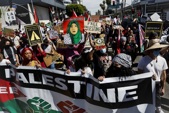 Protesters gather during a demonstration in support of Palestinians calling for a ceasefire in Gaza as the 96th Academy Awards Oscars ceremony is held nearby, Sunday, March 10, 2024, in the Hollywood  ...