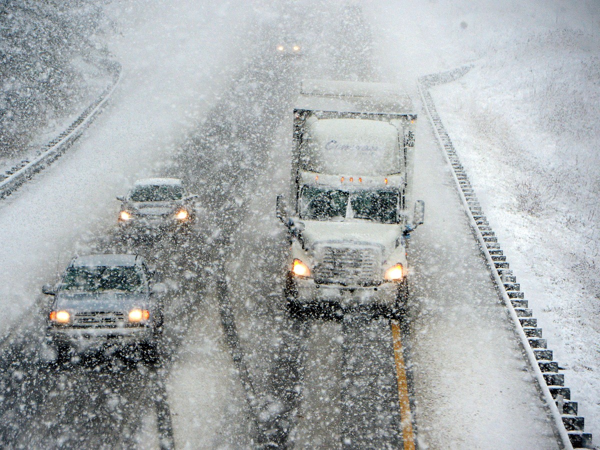Motorists brave the falling snow as they head south on Interstate 81 near Staunton, Va., Wednesday, Nov. 26, 2014. One of the busiest, most stressful travel days of the year posed special challenges i ...