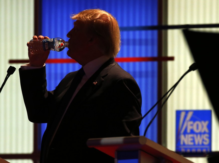 Republican presidential candidate, businessman Donald Trump takes a drink of water during a commercial break at a Republican presidential primary debate at Fox Theatre, Thursday, March 3, 2016, in Det ...