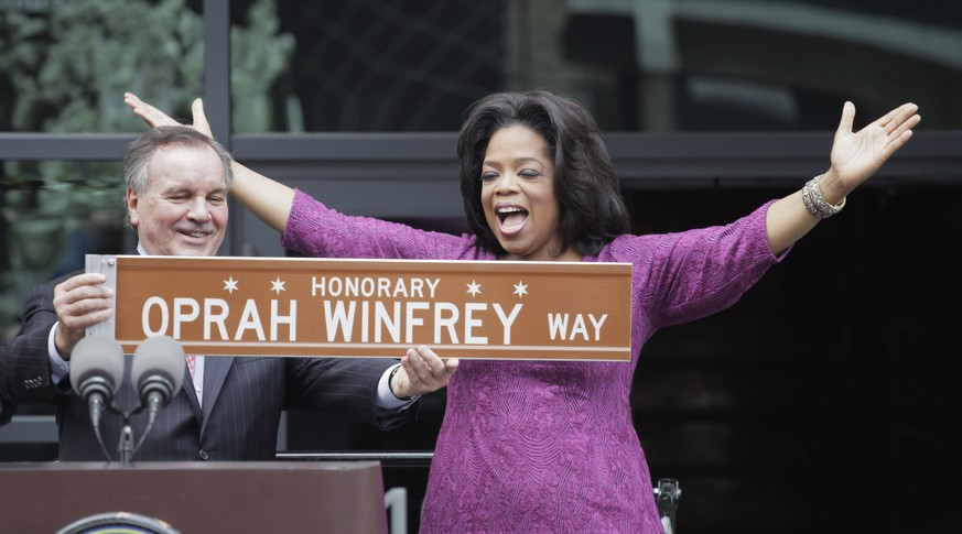 FILE-This May 11, 2011, file photo shows Chicago Mayor Richard M. Daley presenting TV talk-show host Oprah Winfrey with a sign after a street was named in her honor outside her Harpo Studios in Chicag ...