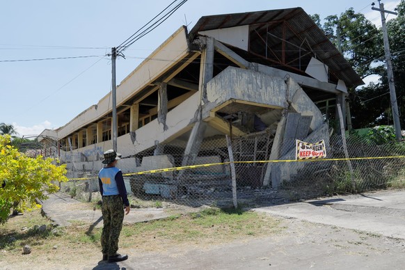 A policeman looks at an abandoned building that collapsed after an earthquake struck in Matanao, Davao del Sur province, Philippines on Monday June 8, 2026.(AP Photo/Nycel Basillote)
Philippines Earth ...
