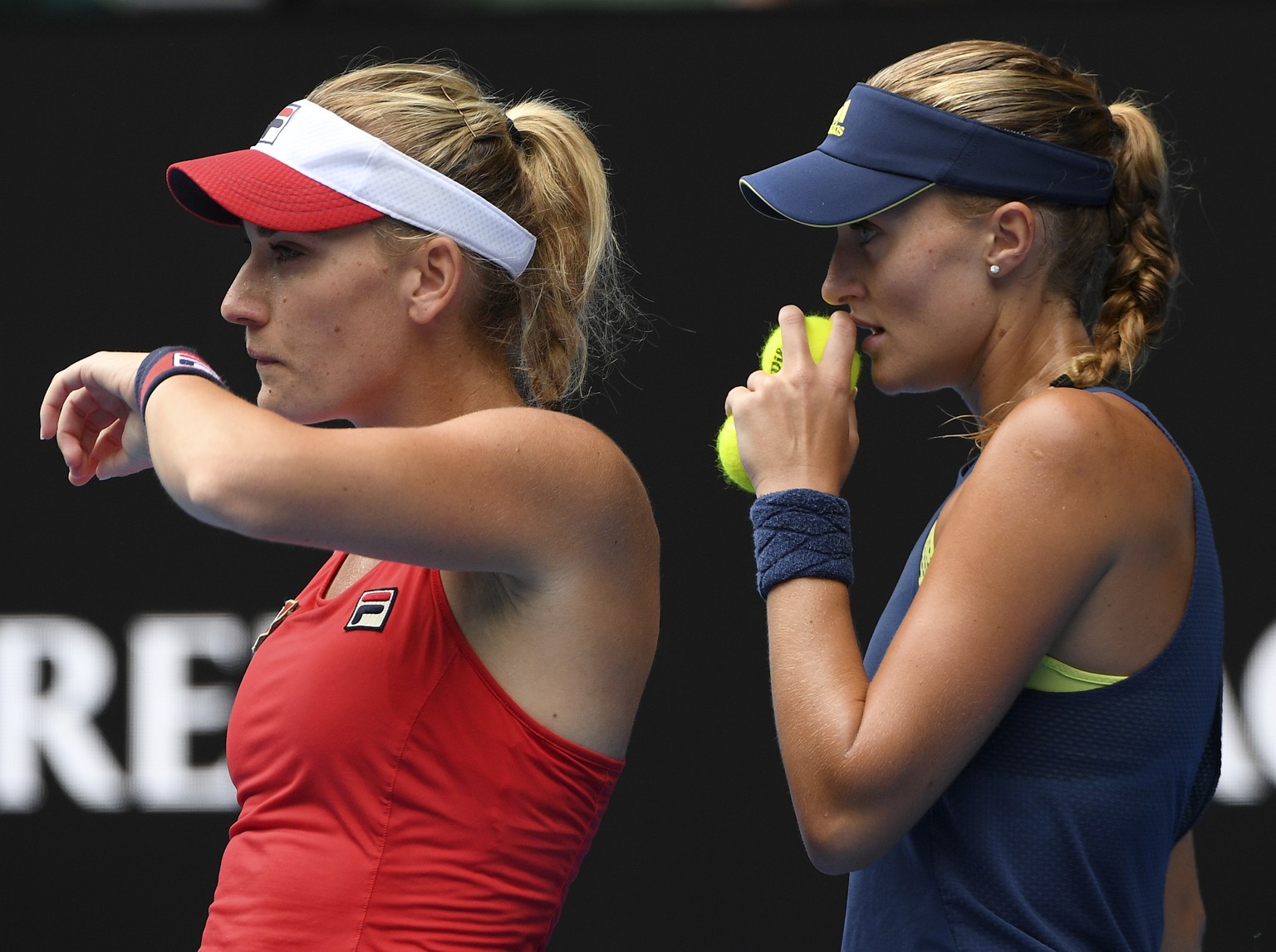 CORRECTS TO MLADENOVIC - Hungary&#039;s Timea Babos, left, and France&#039;s Kristina Mladenovic talk tactics against Russia&#039;s Ekaterina Makarova and Elena Vesnina during the women&#039;s doubles ...