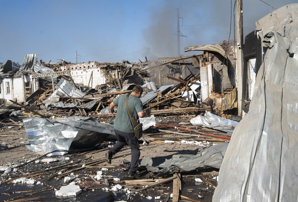 KEYPIX - epa13166036 A local resident inspects the site of a Russian airstrike that struck a storage facility with four guided aerial bombs in Kramatorsk, Donetsk region, Ukraine, 13 August 2026, amid ...