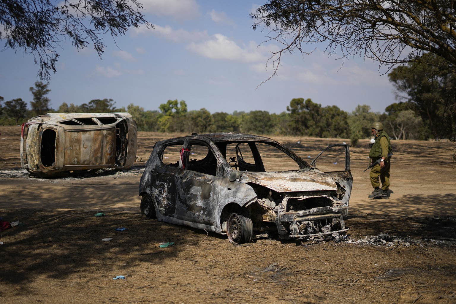 FILE - Israeli soldiers inspect the site of a music festival near the border with the Gaza Strip in southern Israel, Friday. Oct. 13, 2023. Body camera footage has emerged, Saturday, Nov. 4, showing I ...