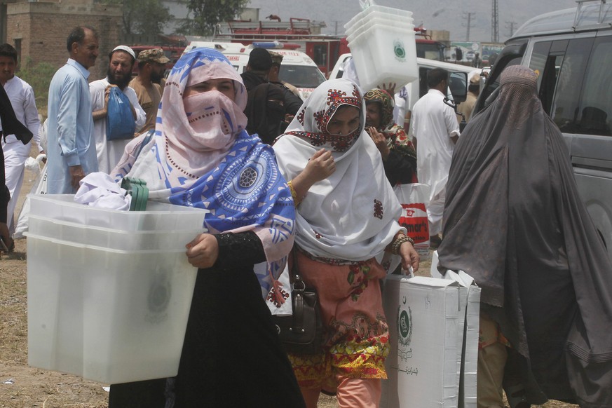 Pakistani election staff carry ballot boxes for elections in Pakistani tribal areas, in Peshawar, Pakistan, Friday, July 19, 2019. The Election Commission of Pakistan (ECP) has finalized all arrangeme ...